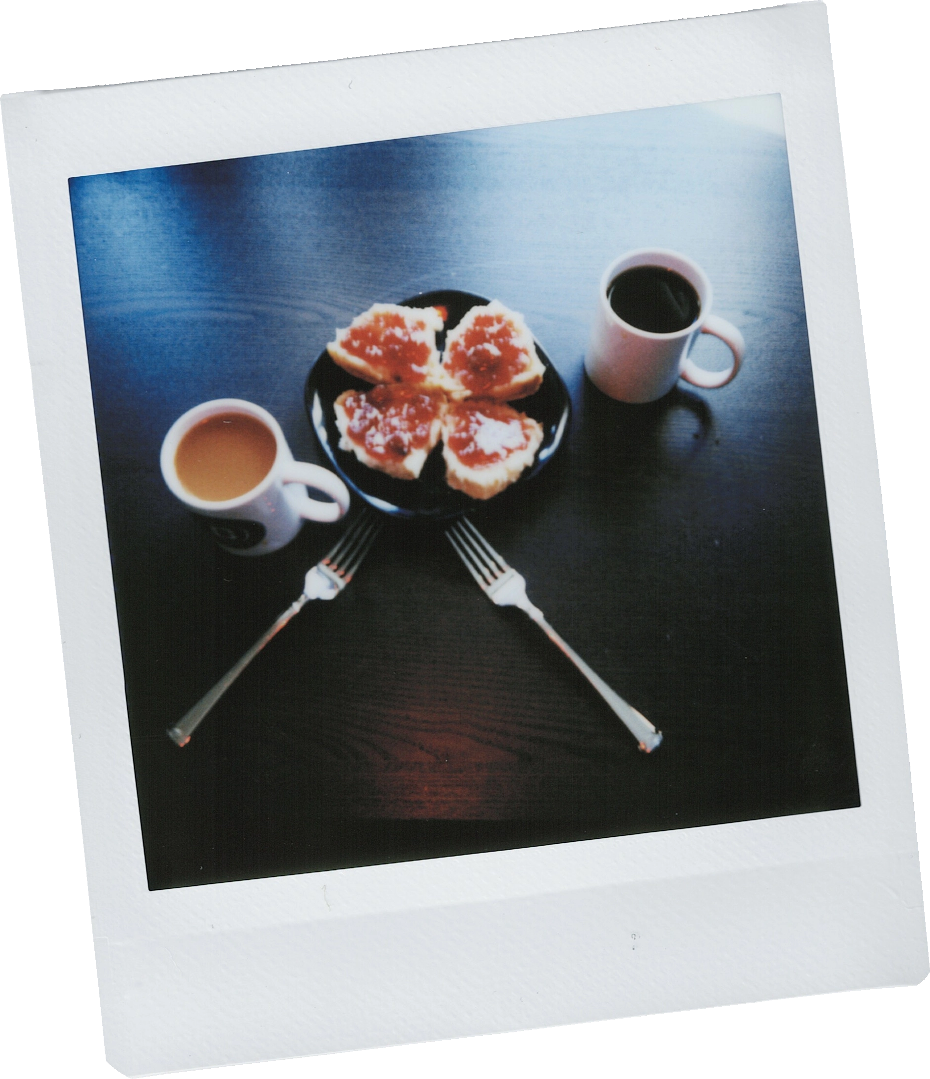 Photo of a buscuit with jam and two coffees - the image is lit from behind, and has warm and cool tones